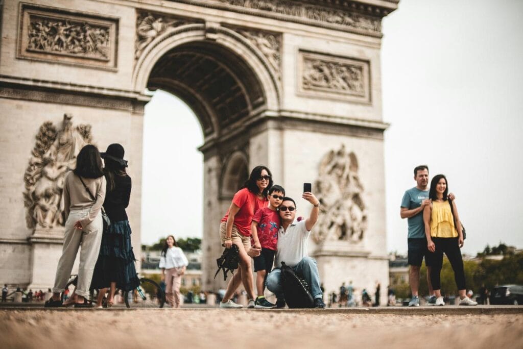 a family of 3 taking a selfie in paris