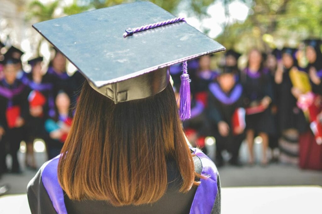 young woman in graduation cap with purple tassel