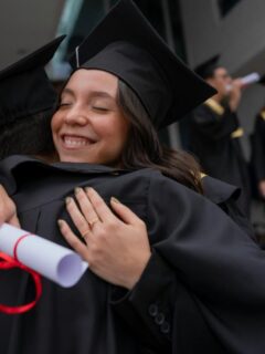 graduates hugging