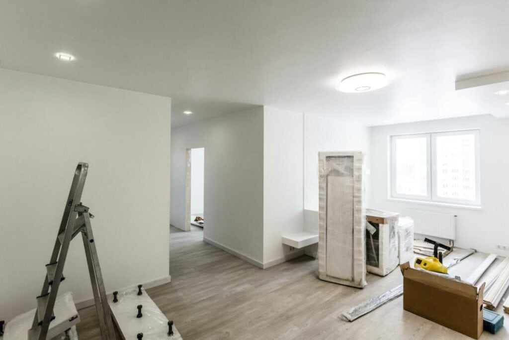 Newly renovated room with fresh flooring, lighting, and materials, showcasing long-lasting home improvement and durability