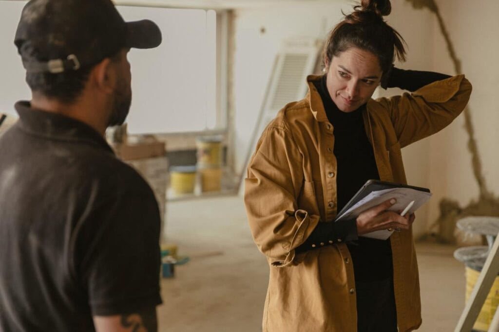 Homeowner discussing renovation plans with contractor, highlighting careful planning for durable and lasting home upgrades