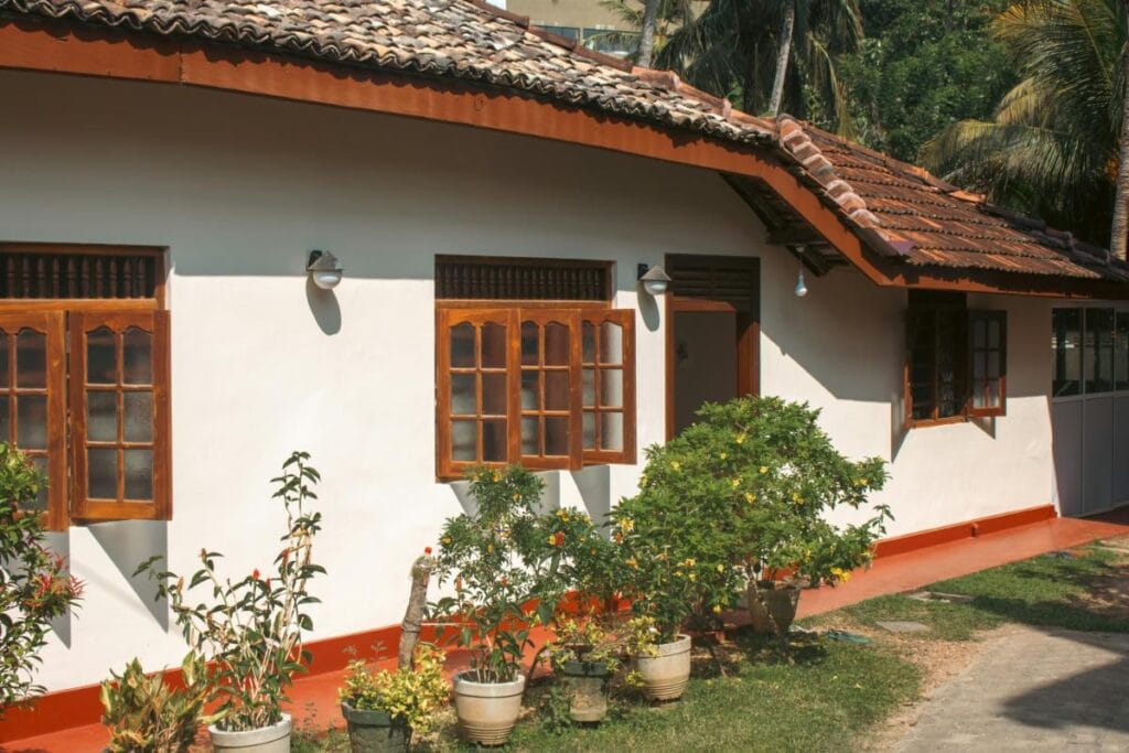 a white single story home with wood-framed windows