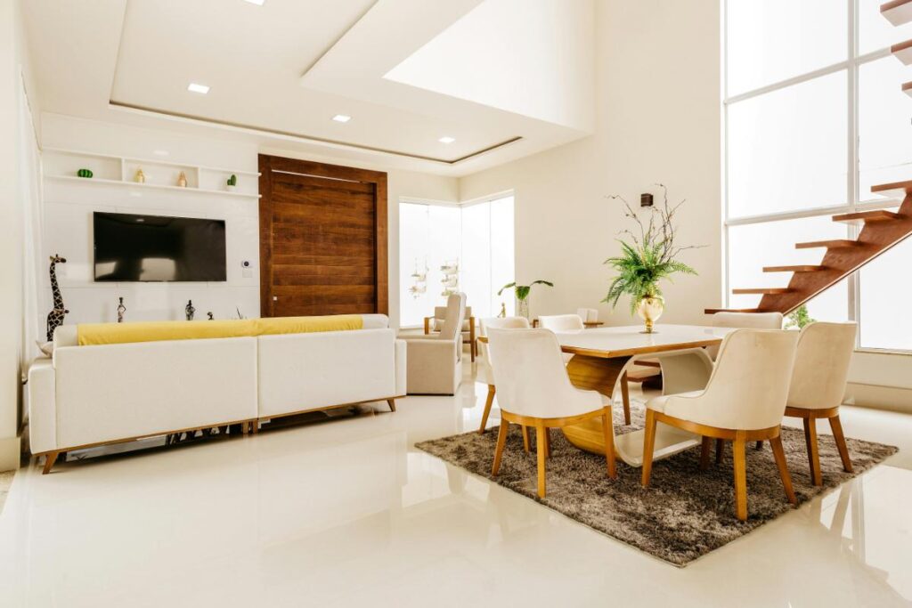 Bright and spacious living and dining room with neutral tones, natural light, and minimalist decor, highlighting a clean and cohesive home interior layout