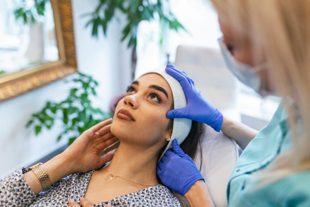 woman in aesthetician's office getting a consultation for beauty treatments