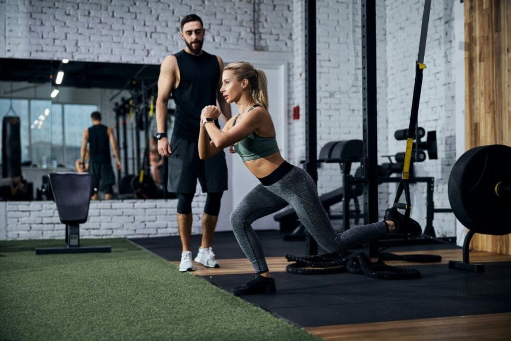 client working with client using bands for leg work