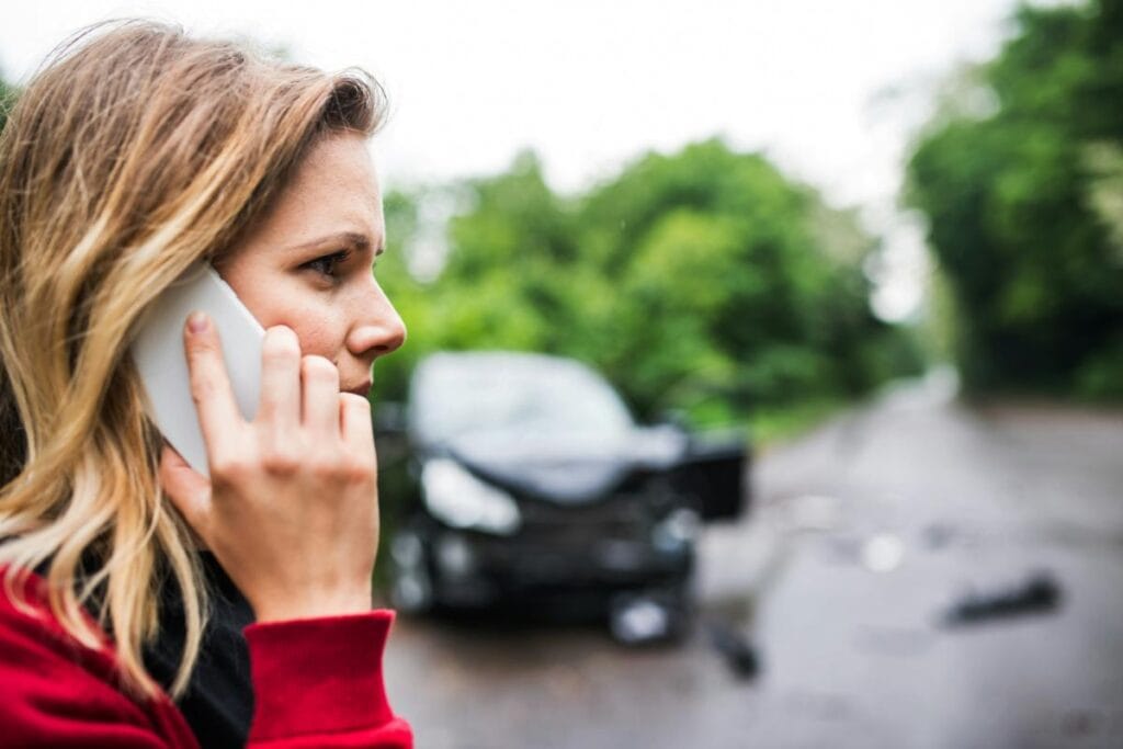 woman on the phone after having a car accident