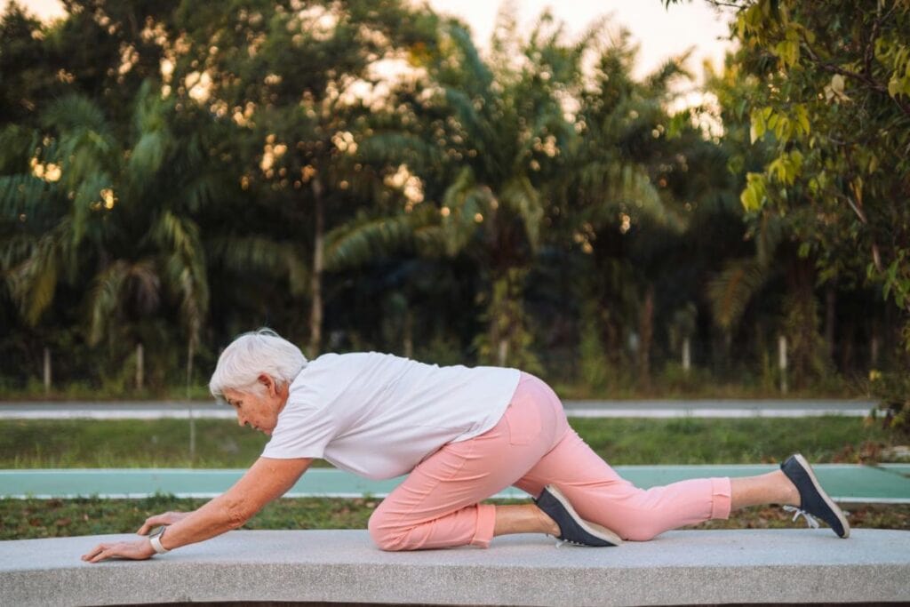 an older woman stretching outdoors