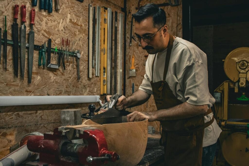 man using carpentry tools in workshop