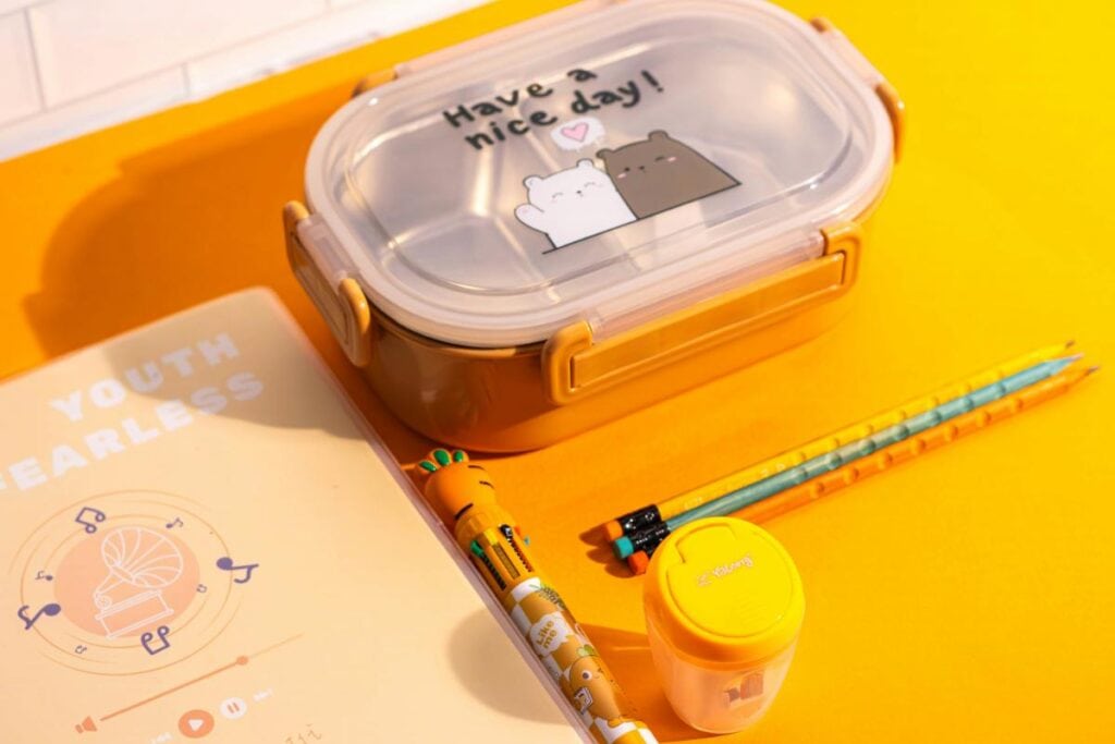 bento box with pencils and notebook