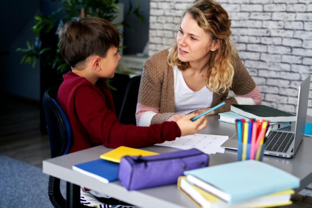 tutor and little boy working together