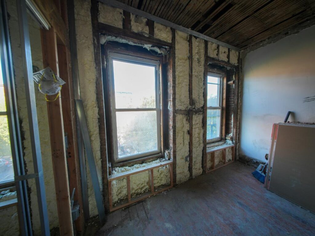 room with drywall removed and insulation showing in walls