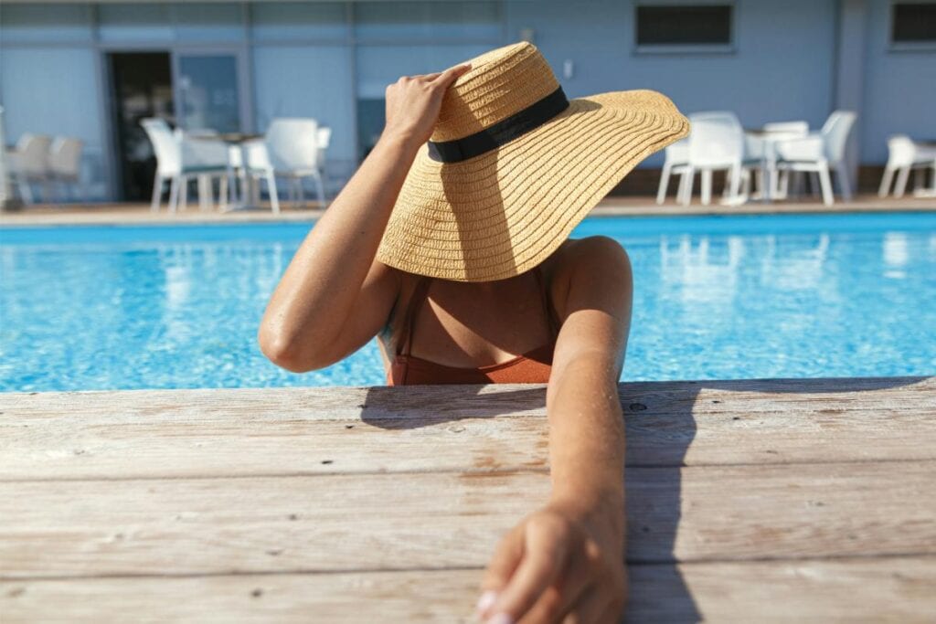 woman in hat in the pool