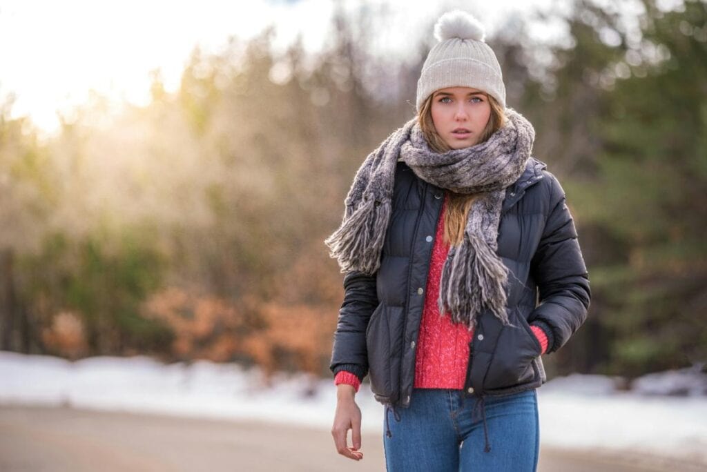 woman in winter coat and bright red sweater