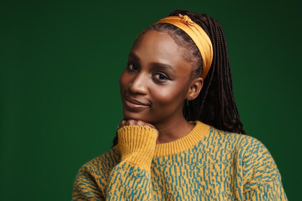 smiling young woman in yellow sweater and matching headband