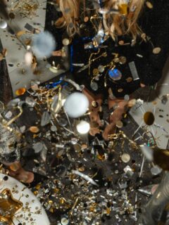 confetti and women with wine glasses around a table