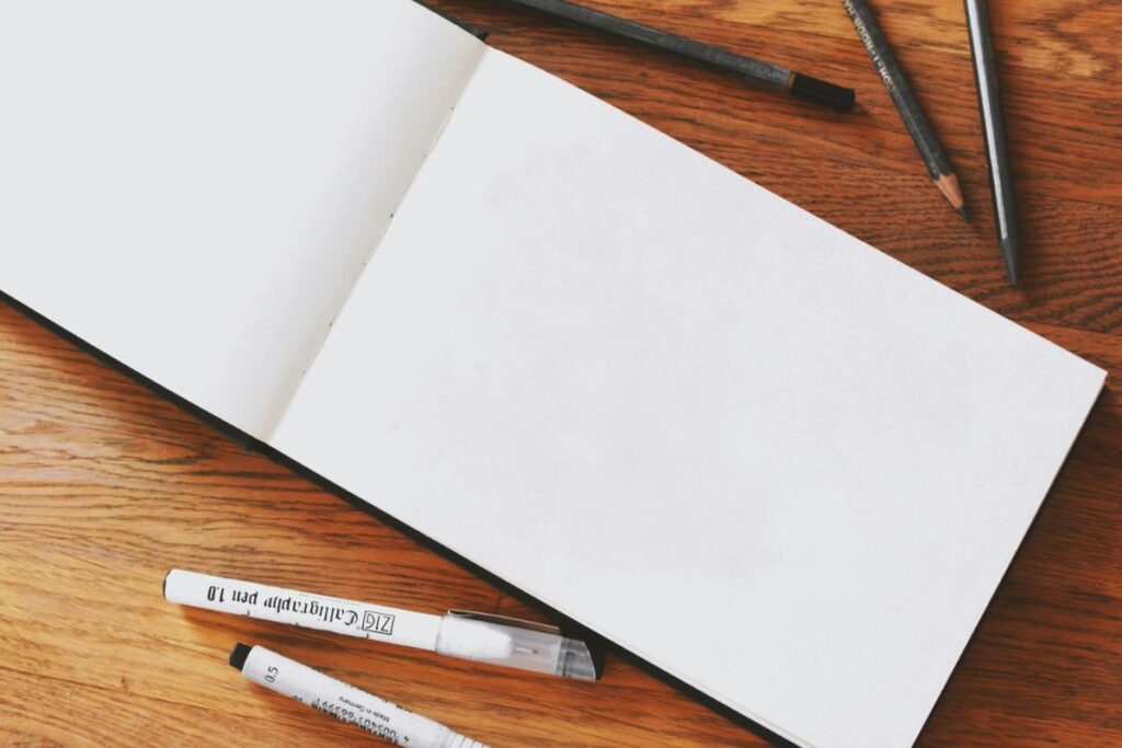 empty sketchpad with drawing pens