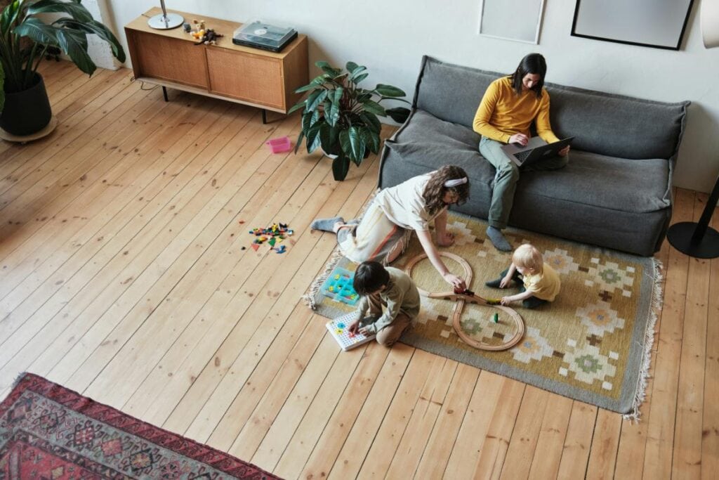 family spending time together in living room with hardwood floors