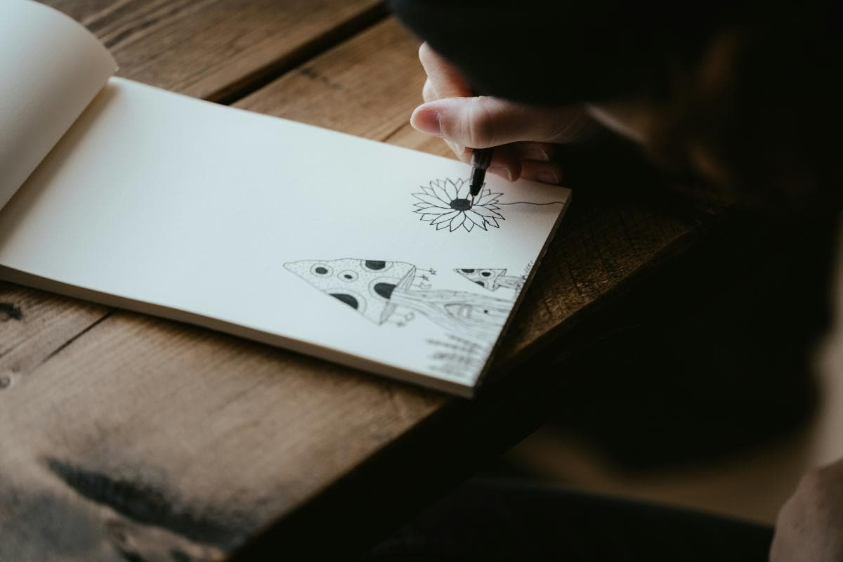 person drawing on a sketchpad
