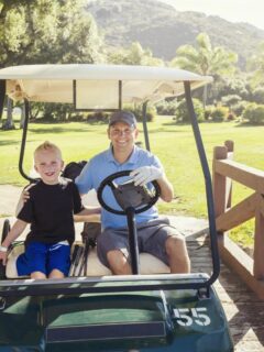 father and son in golf cart