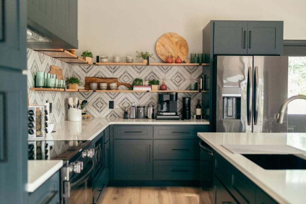 a kitchen reno with dark cabinets and decorated shelves