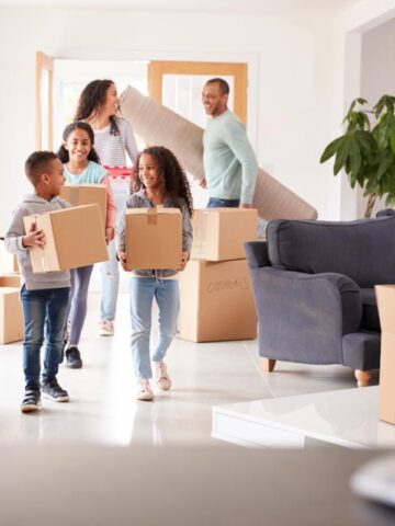 family with moving boxes in living room