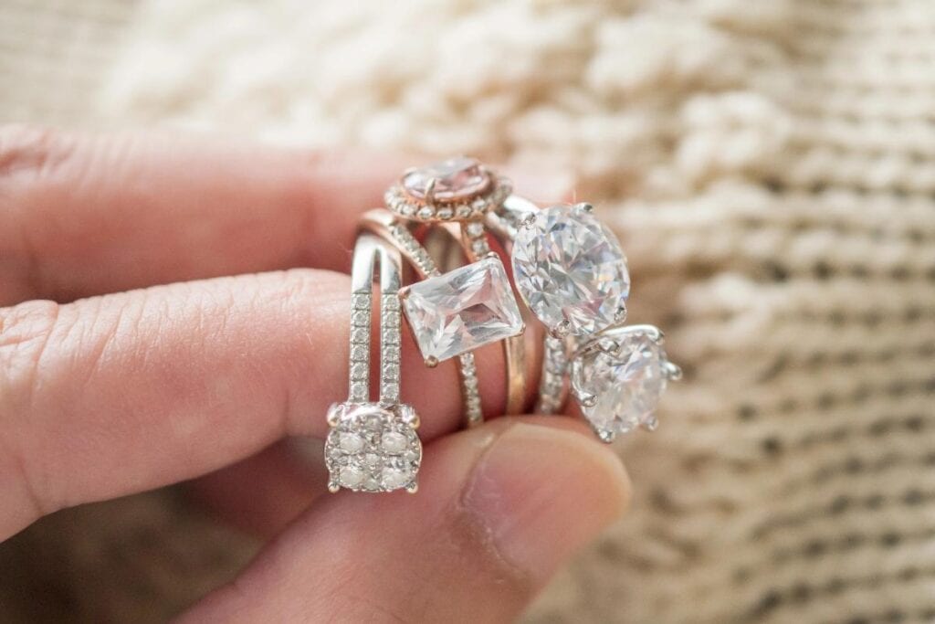 hand holding 4 engagement ring possibilities