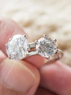 hand holding two engagement rings for comparison