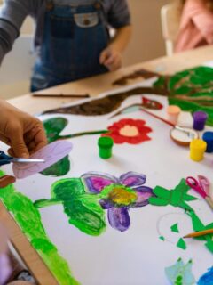 Children creating colorful arts and crafts project at a table