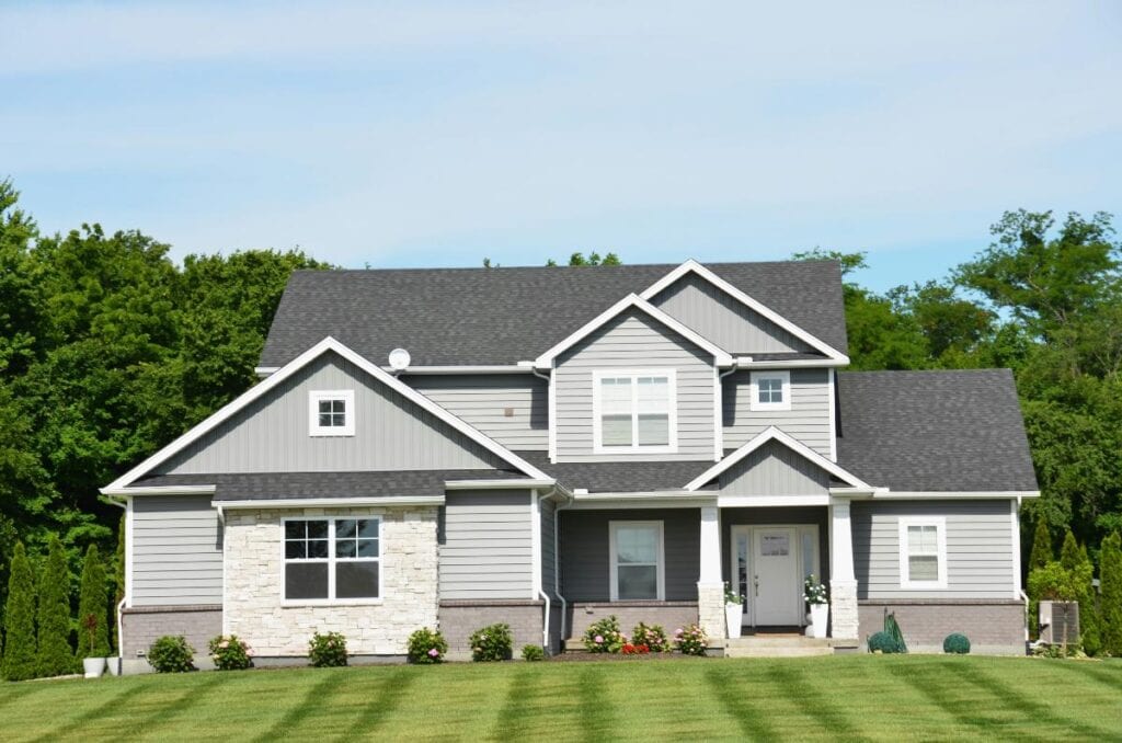 A modern suburban family home exterior with a front lawn