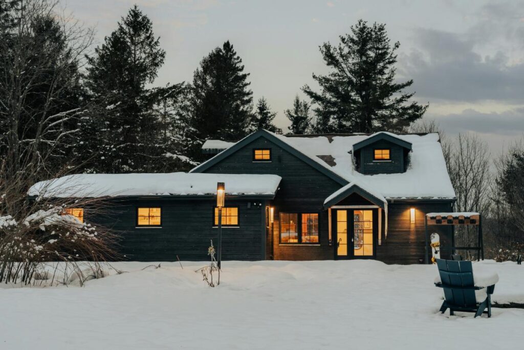 large house in winter landscape with snow on roof
