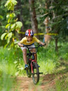 little boy riding bike on trail
