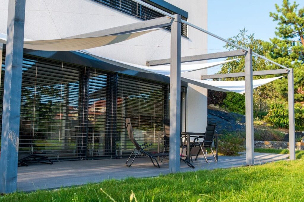 Modern patio with outdoor shade system for sun protection.