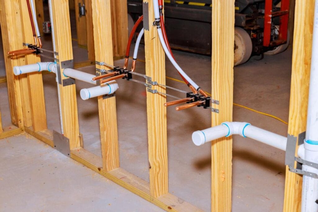 New plumbing rough-in installed during a basement renovation project.