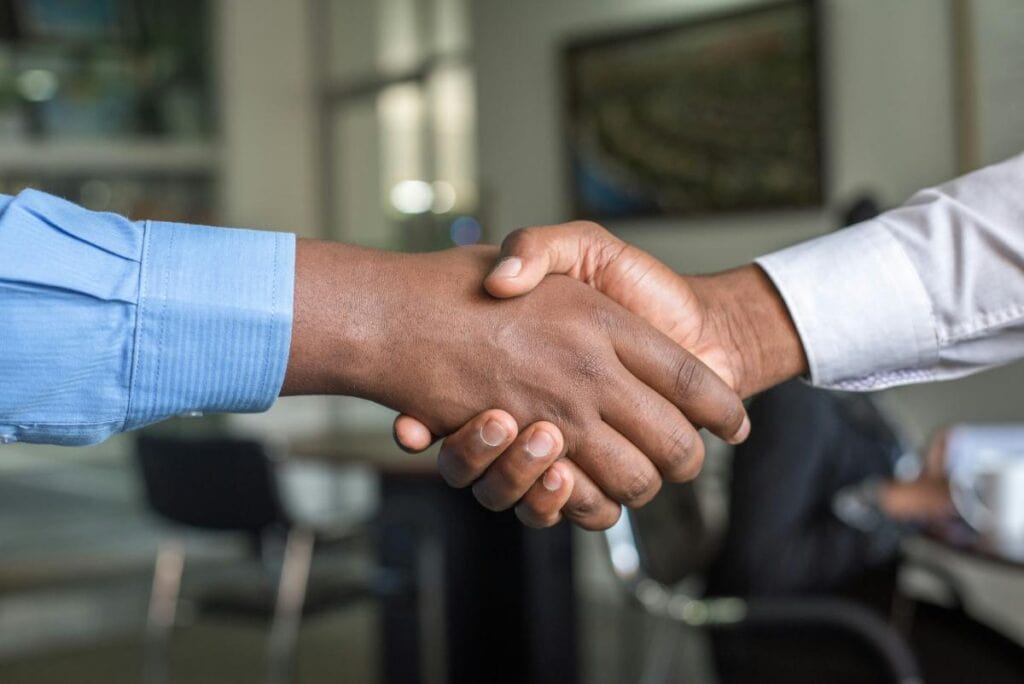 Two people shaking hands closing a real estate deal