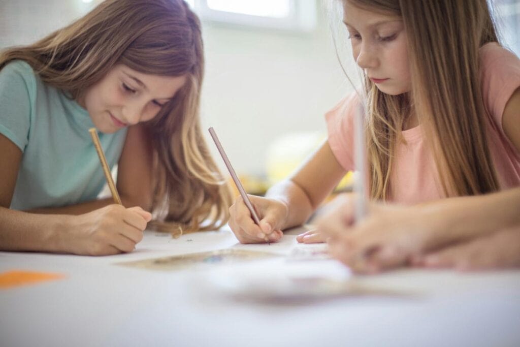 two young girls writing poems
