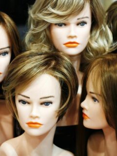 Display of wigs in various colors and styles for people experiencing hair loss.