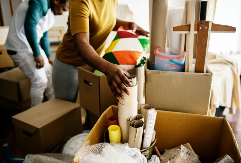 Household items sorted into cardboard boxes for practical home organization and storage.