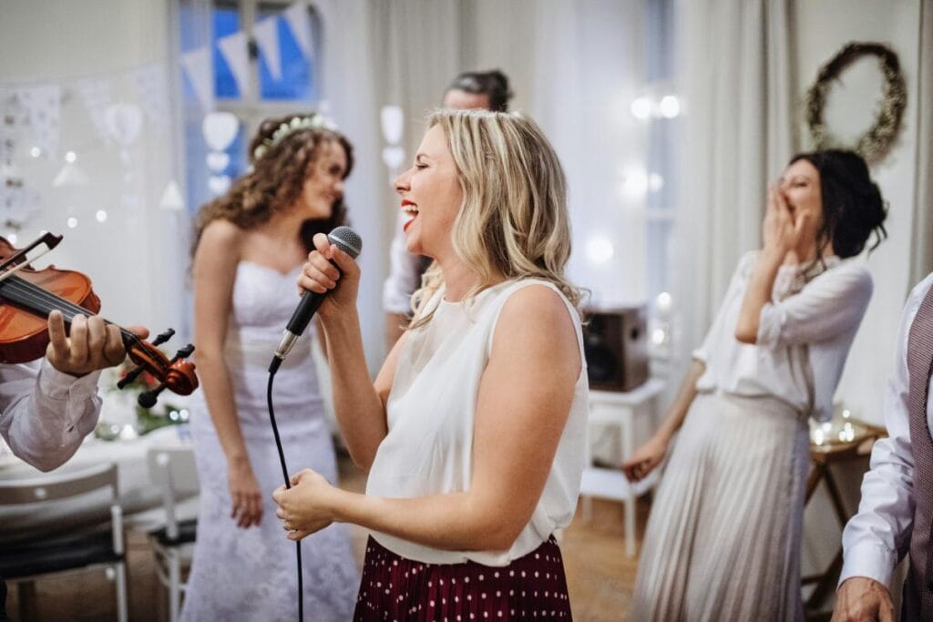 woman singing or giving speech at wedding reception