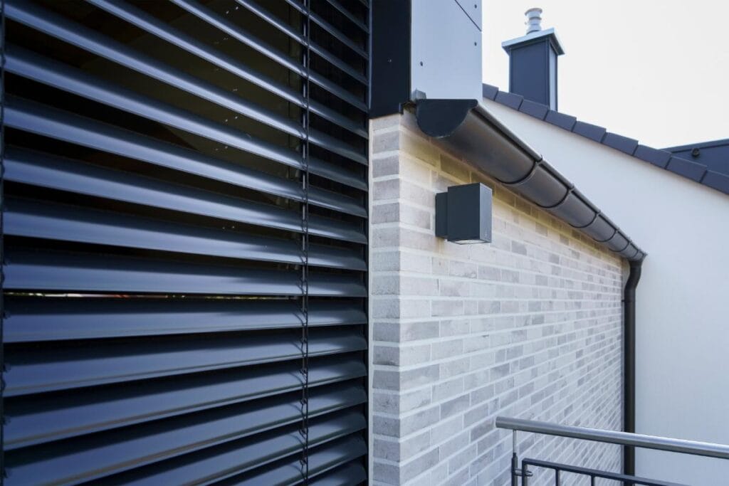 black external blinds on house window