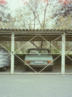 Covered residential carport providing sheltered parking for multiple vehicles