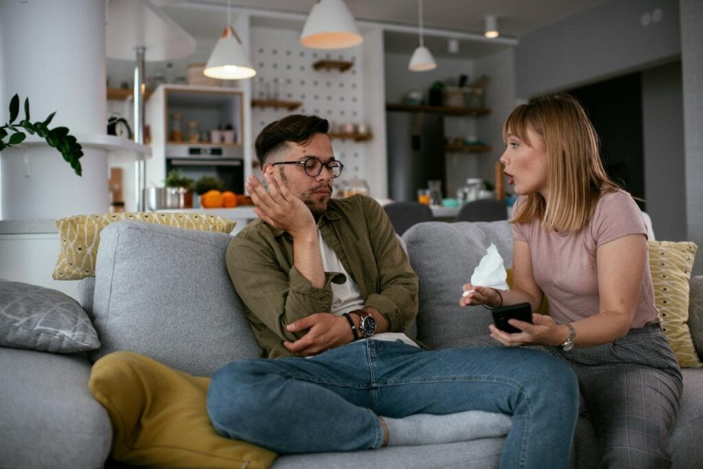 Couple having a difficult conversation on the couch.