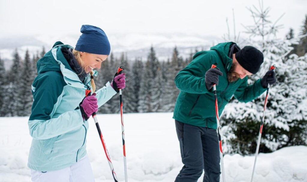 couple laughing and skiing