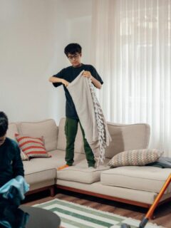 a family of 3 cleaning the living room