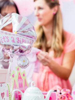 Baby shower gifts and decorations celebrating a new baby girl.