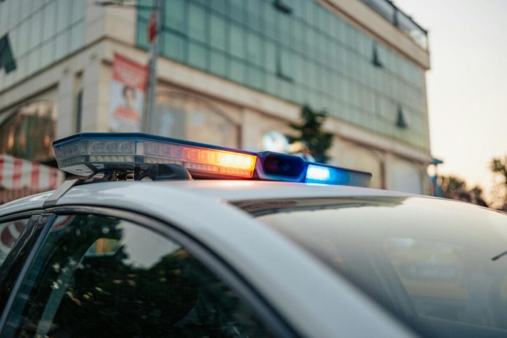 lights on police car arriving at the scene of a car accident