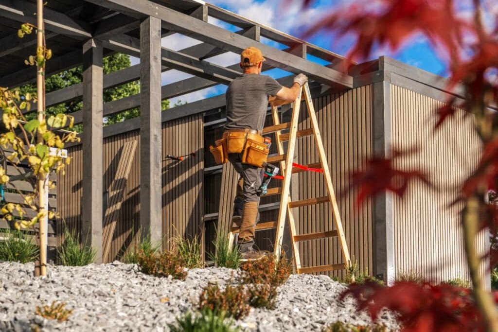 Professional builder constructing a modern residential carport frame