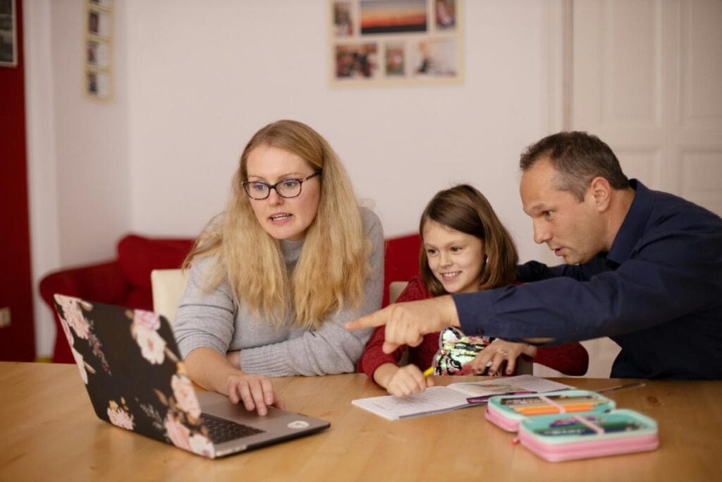 family looking at laptop for financial planning