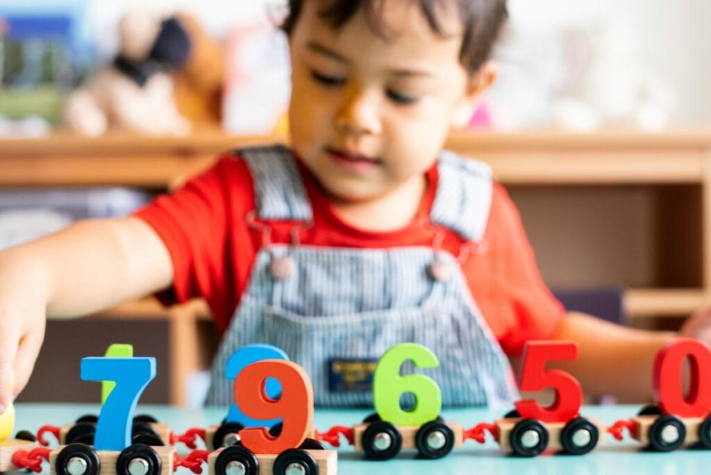 Preschooler learning numbers through hands-on play.