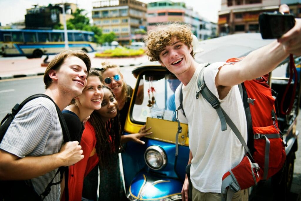 teenagers traveling internationally pose for a selfie