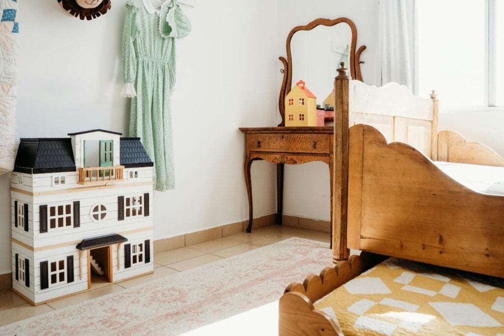 child's room with dollhouse against the wall